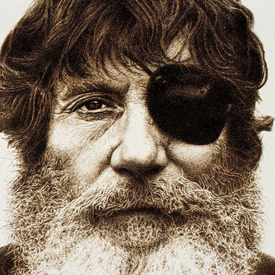Black and white portrait of a man with a beard and eye patch, with text indicating 'Jack O'Neill 1923 - 2017'.