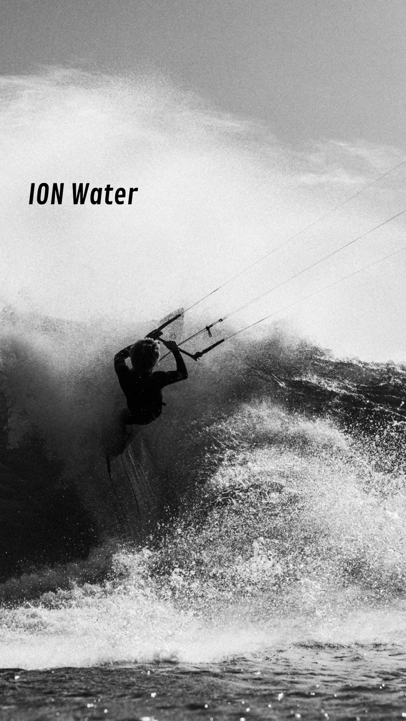 Person kite surfing on a large wave with 'ION Water' branding. - urbaneight