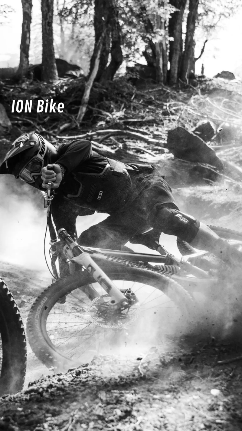 Person riding a mountain bike on a dirt trail with 'ION Bike' branding. - urbaneight